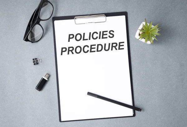 Policy and procedure text concept write on notebook with pen