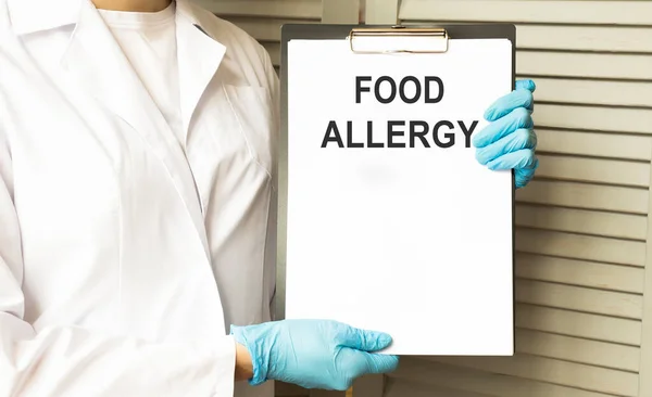 Doctor holding a tablet pc with Food Allergy sign on the display