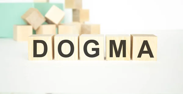 DOGMA word written on wood block on a light background