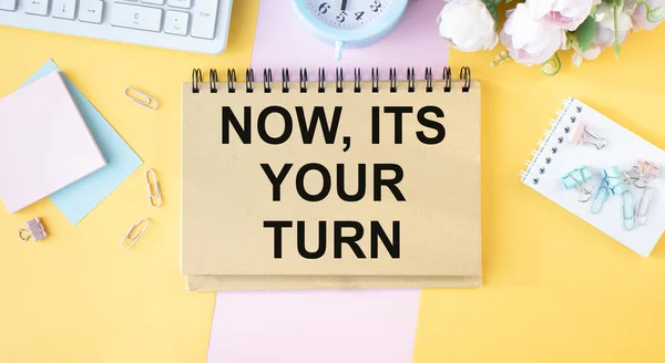 words NOW ITS YOUR TURN in black letters on business card put on wooden table. Business concept.