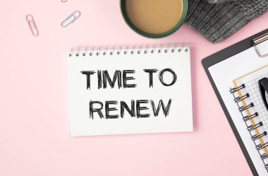 Aydınlık bir arkaplan, gözlük ve kırtasiye yakınında yenilenecek metin zamanını not et.