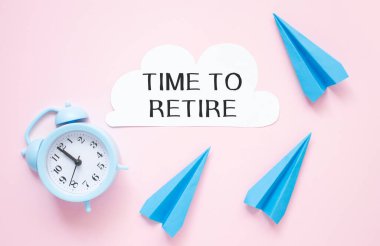 Beyaz kağıt üzerinde emekli olma zamanı. Yanında saat işliyor..