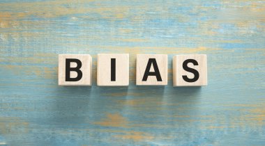 wooden cubes and BIAS, coins, the concept of taxation, increase taxes and fees
