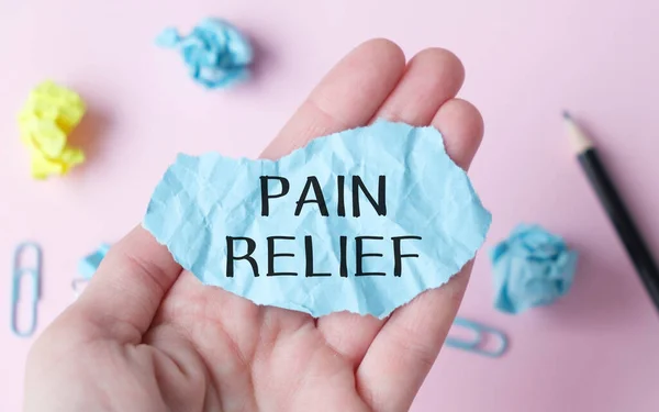 Pain Relief blue paper in hand of Medical Doctor