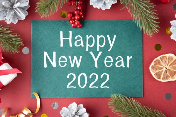 Happy New Year 2022 Sign In Lightbox And Gold Celebration Toys, Candles And Champagne On Bokeh Background. Happy 2022 Year Abstract Concept. Square Image Banner.