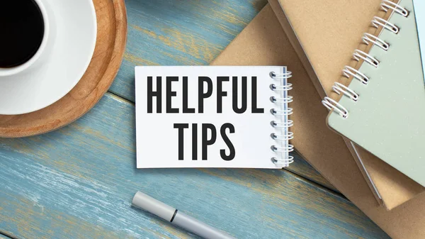 Helpful tips text write on paper as wooden background