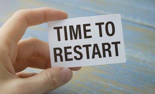 businesswoman holding a black paper plate with text TIME TO RESTART