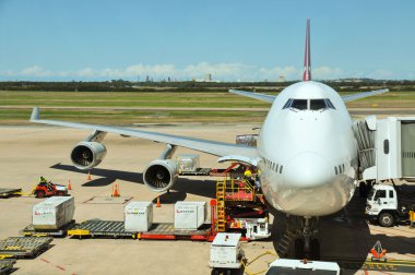 Qantas Boeing 747-400 is being loaded clipart