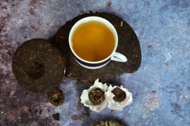 Çeşitli Çinlilerin puer çay kreplerinin olduğu bir fincan çay. Yüksek kalitede Çin porseleni çayı..