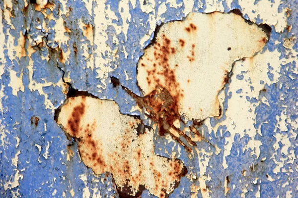 Rusty surface background. Corroded metal background. Rusted blue painted metal wall. rust and old blue and yellow paint on a metal surface.