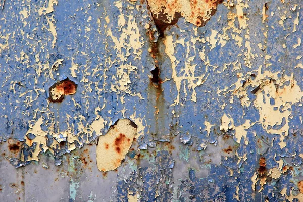 Rusty surface background. Corroded metal background. Rusted blue painted metal wall. rust and old blue and yellow paint on a metal surface.