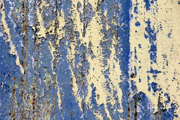 Rusty surface background. Corroded metal background. Rusted blue painted metal wall. rust and old blue and yellow paint on a metal surface.