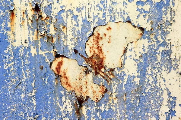 Rusty surface background. Corroded metal background. Rusted blue painted metal wall. rust and old blue and yellow paint on a metal surface.