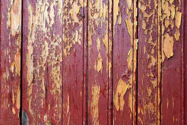 Ahşap tahtaların üzerinde eski kırmızı boya. Kırmızı boyalı iplikçik ahşap. 