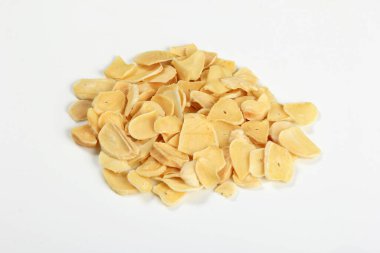 Dried garlic flakes on white background. Dried vegetables
