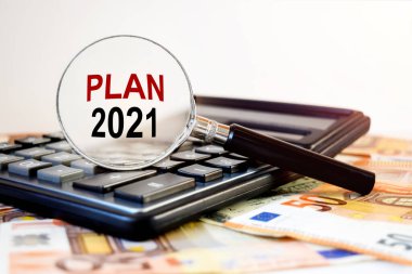 Hesap makinesi ve banknotların yanında, kabartma camında yazılı metin satılıyor.