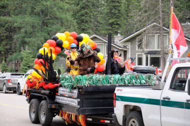 Waskesiu, Saskatchewan, Canada - July 1, 2019: Colorful parade floats and people take part in a parade to celebrate Canada Day in Prince Albert National Park.