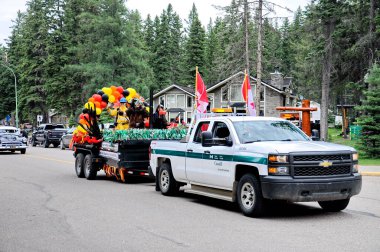 Waskesiu, Saskatchewan, Canada - July 1, 2019: Colorful parade floats and people take part in a parade to celebrate Canada Day in Prince Albert National Park.