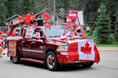 Waskesiu, Saskatchewan, Canada - July 1, 2019: Colorful parade floats and people take part in a parade to celebrate Canada Day in Prince Albert National Park.