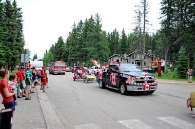 Waskesiu, Saskatchewan, Canada - July 1, 2019: Colorful parade floats and people take part in a parade to celebrate Canada Day in Prince Albert National Park.