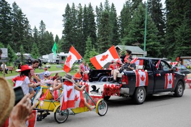 Waskesiu, Saskatchewan, Canada - July 1, 2019: Colorful parade floats and people take part in a parade to celebrate Canada Day in Prince Albert National Park.