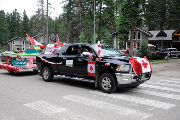 Waskesiu, Saskatchewan, Canada - July 1, 2019: Colorful parade floats and people take part in a parade to celebrate Canada Day in Prince Albert National Park.
