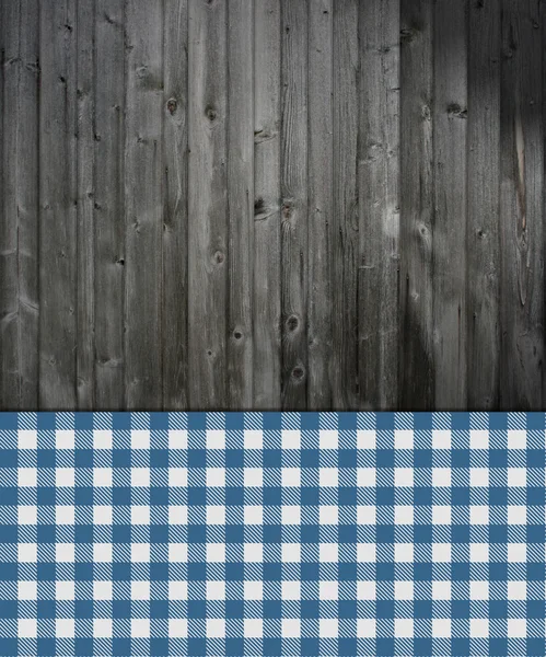 Houten achtergrond met blauw tafelkleed — Stockfoto