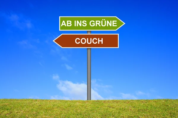 Sign with two arrows shows Couch or go outside german — Stock Photo, Image