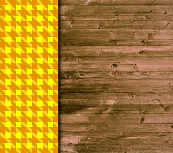 Traditional wooden background with orange yellow tablecloth — Stock Photo, Image