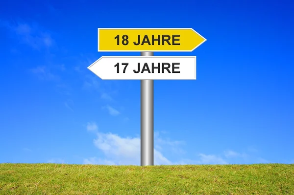 Signpost showing 17 years or 18 years in german — Stock Photo, Image