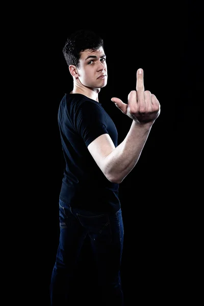 Young man showing his middle finger — Stock Photo, Image