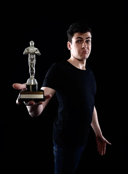 Young man holding fake oscar award — Stock Photo, Image