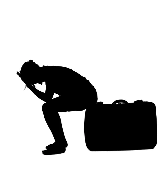 Stressed woman silhouette - sitting on luggage — Stock Photo, Image