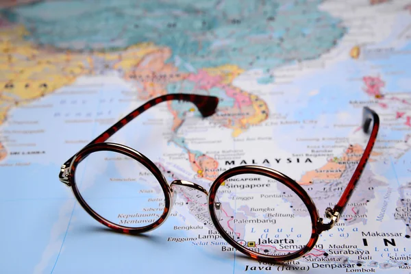 Glasses on a map of Asia - Jakarta
