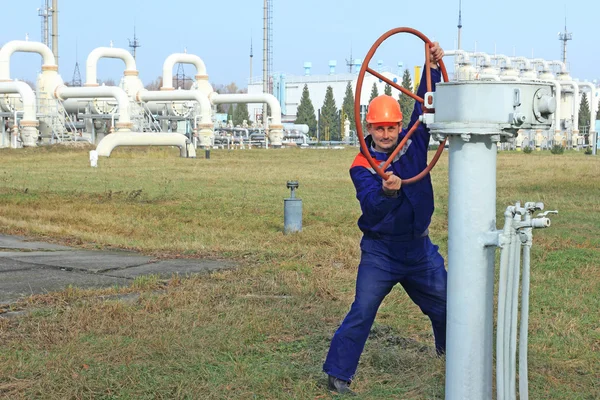 Worker opening big valve — Stock Photo, Image