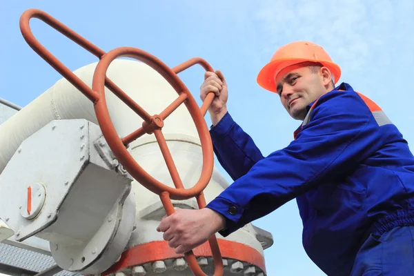 Worker turns valve — Stock Photo, Image