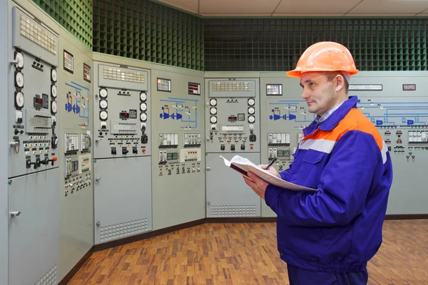 Engineer with log on main control panel — Stock Photo, Image