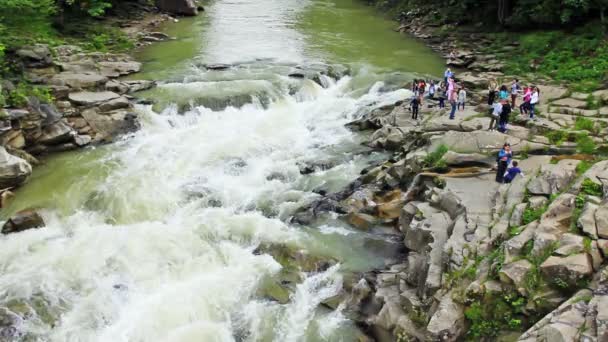 Touristen an Land in der Nähe des Wasserfalls — Stockvideo