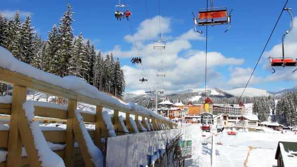 Elevadores de esqui se movendo sobre ponte e casas — Vídeo de Stock