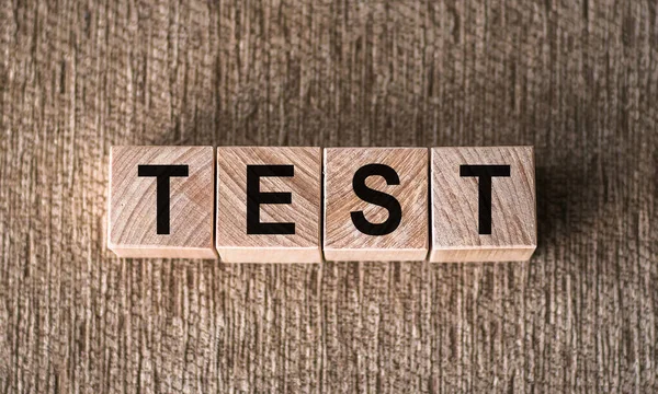 Test word made of wood background. Business concept. Test sign, exam, learning concept. Word test written with wooden cubes. Education quality control. Test background