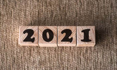 Yeni yıl konsepti. afiş için kahverengi arkaplandaki ahşap küplerle ilgili yazı tipi 2021