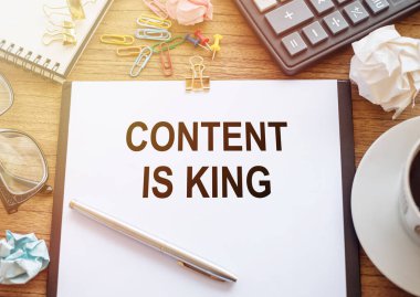 Metin içeriğine sahip ofis kağıdı, arkaplan için ahşap masadaki kral ve ofis araçlarıdır