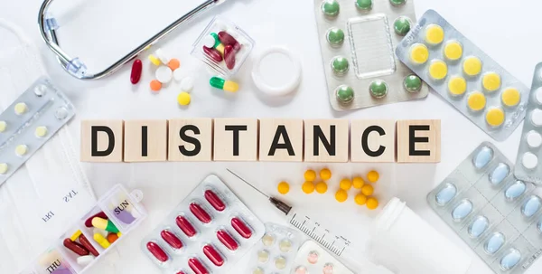 Distance Word Wooden Blocks Desk Medical Concept Pills Vitamins Stethoscope — Stock Photo, Image
