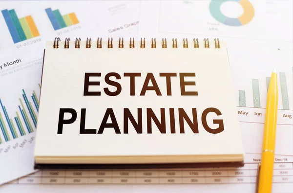 ESTATE PLANNING- written on notepad on financial charts and graphs with yellow pen.