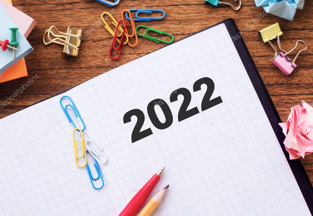 2022 is written in a notebook on the office desk. The concept of business and finance.