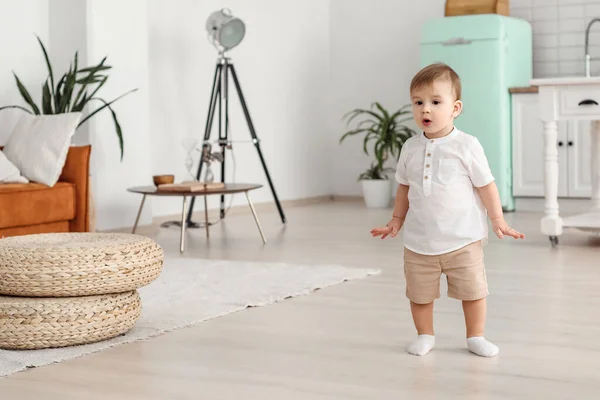 Dancing at home to the music. The child runs and smiles in a cheerful mood.