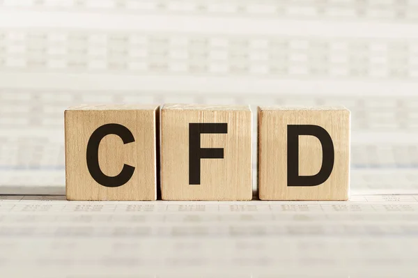 CFD abbreviation - Contract For Difference, on wooden cubes on a light background.