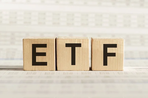 ETF kısaltması - Borsa Ticaret Fonu, hafif bir arkaplan üzerinde tahta küpler.