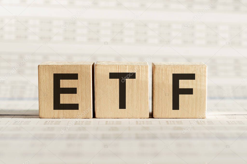 ETF abbreviation - Exchange Traded Fund, on wooden cubes on a light background.
