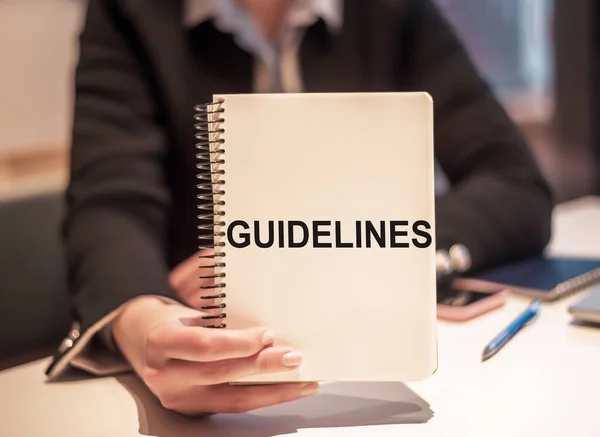 Business Woman Holds Notebook Text Guidelines — Photo